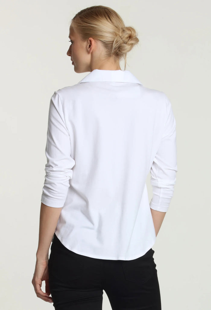A woman with blonde hair tied back is wearing the HINSON WU DONNA 3/4 SLEEVE TOP and black pants, standing against a plain light background and looking at the camera.