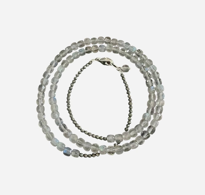 The ANN LIGHTFOOT Triple Wrap Square Cut Labradorite and Pyrite Bracelet features three strands of square-cut labradorite and pyrite beads, arranged in layers and finished with a sleek sterling silver clasp.