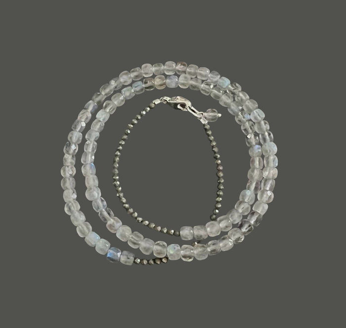 The ANN LIGHTFOOT Triple Wrap Square Cut Labradorite and Pyrite Bracelet features three strands of square-cut labradorite and pyrite beads, arranged in layers and finished with a sleek sterling silver clasp.