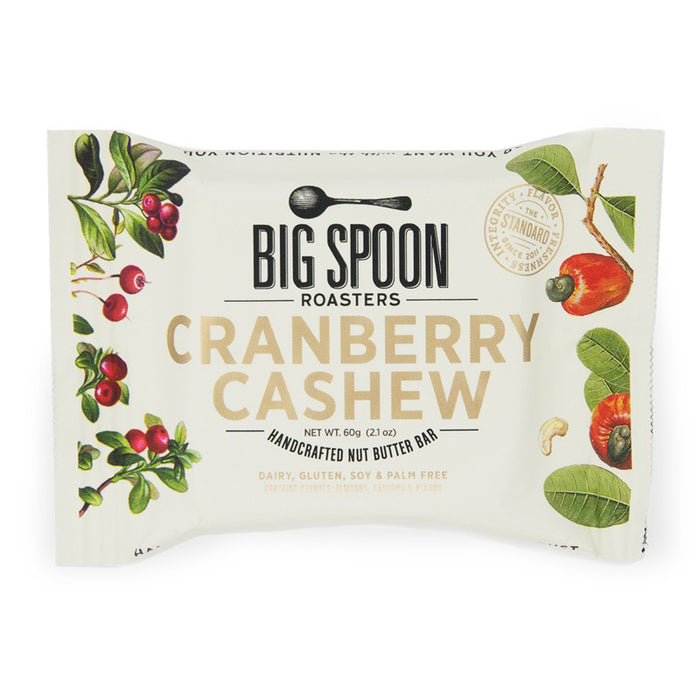 A BIG SPOON ROASTERS - CRANBERRY CASHEW SNACK BAR, by BIG SPOON ROASTERS, with cranberry and cashew illustrations on a cream background. This non-GMO bar is dairy free, gluten free, soy free, and palm oil free for a wholesome snack.