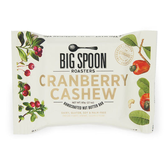 A BIG SPOON ROASTERS - CRANBERRY CASHEW SNACK BAR, by BIG SPOON ROASTERS, with cranberry and cashew illustrations on a cream background. This non-GMO bar is dairy free, gluten free, soy free, and palm oil free for a wholesome snack.