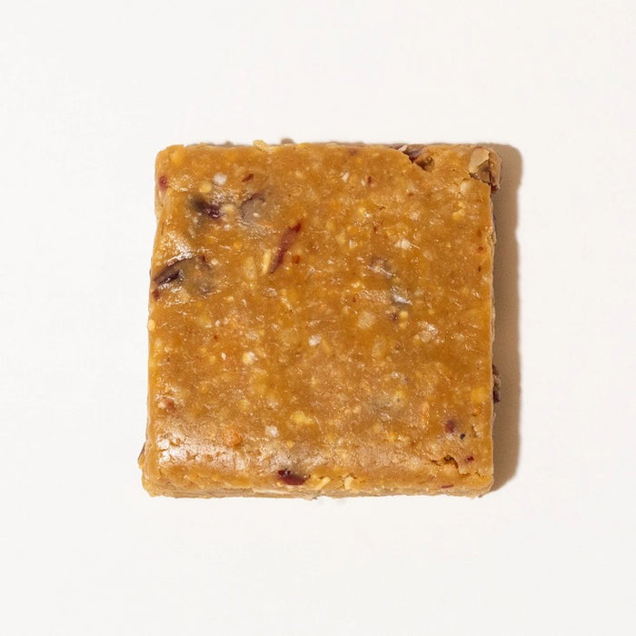 A BIG SPOON ROASTERS - CRANBERRY CASHEW SNACK BAR, by BIG SPOON ROASTERS, with cranberry and cashew illustrations on a cream background. This non-GMO bar is dairy free, gluten free, soy free, and palm oil free for a wholesome snack.