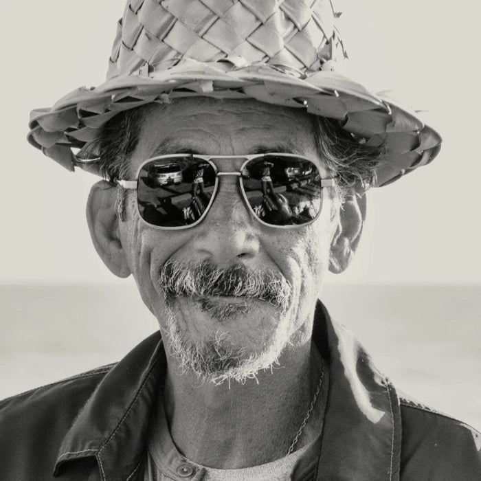 Front view of CADDIS - METAMODERNIST SCOUT SUNGLASSES by CADDIS, featuring an aviator-style sleek metal alloy frame and dark green premium tinted lenses, displayed on a white background.