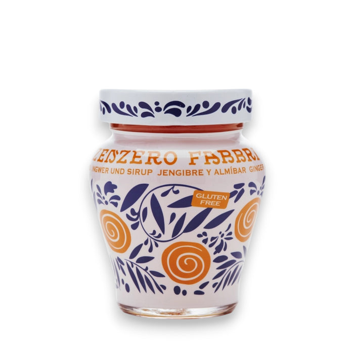A vibrant jar of FABBRI - CANDIED GINGER IN SYRUP by Gourmet Food Solutions, featuring a decorative blue and white lid and an intricate orange and blue design on the glass. The front label prominently displays "Gluten Free." The jar is set against a white background, capturing the essence of candied ginger.
