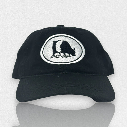 The OUTDOOR CAP FEARRINGTON LIFESTYLE COLLECTION Adult Twill Beltie Cow Hat in black features a white oval patch with a black and white bear silhouette, shown on a light gray textured background. Makes a perfect gift.