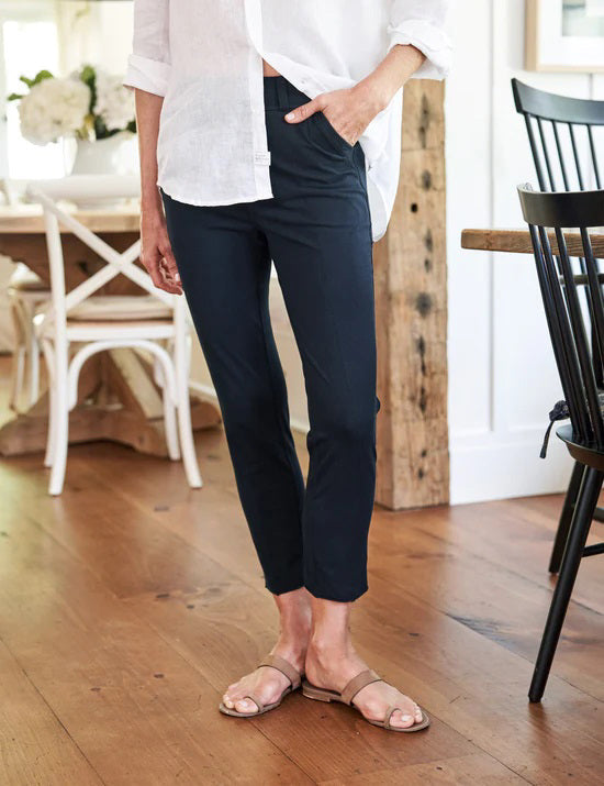 The FRANK & EILEEN Murphy Billion Dollar Pant in black, featuring a tailored waistband and side pockets, is displayed flat on a white textured background.