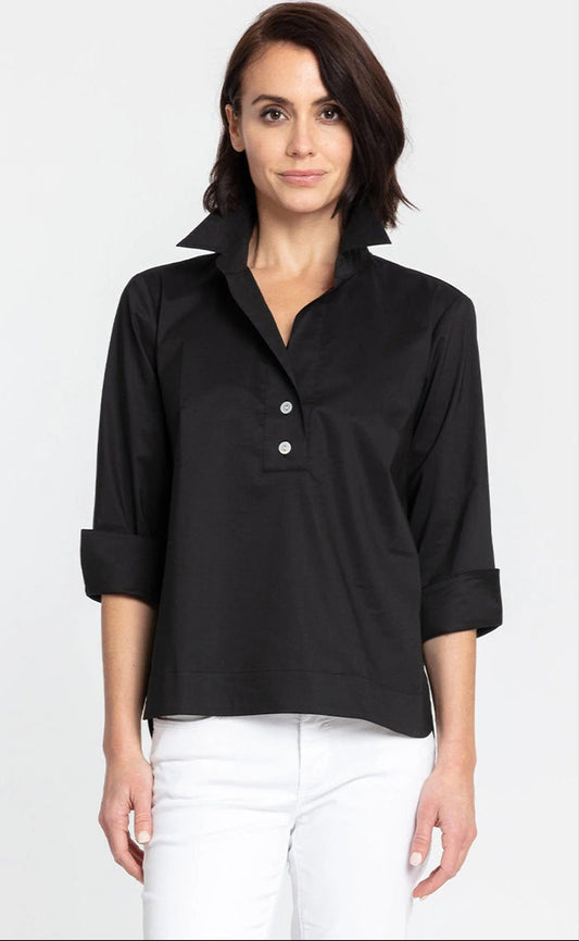 A woman with short dark hair wears the HINSON WU - AILEEN 3/4 SLEEVE POLISHED COTTON SHIRT, styled with white pants, standing against a plain light background.