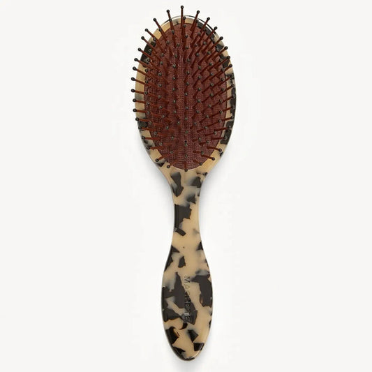 The MACHETE Everyday Detangling Hair Brush in Blonde Tortoise features a tortoiseshell-patterned Italian acetate handle and black-tipped nylon bristles set in a maroon cushion, shown against a plain white background.