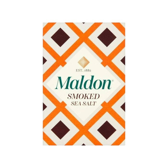 A box of MALDON - SMOKED SEA SALT from GOURMET FOOD SOLUTIONS is shown against a pink background. The box features a geometric design with orange, brown, and white patterns that illustrate the artisanal quality of English sea salt, with the text "MALDON - SMOKED SEA SALT" prominently displayed on the front.