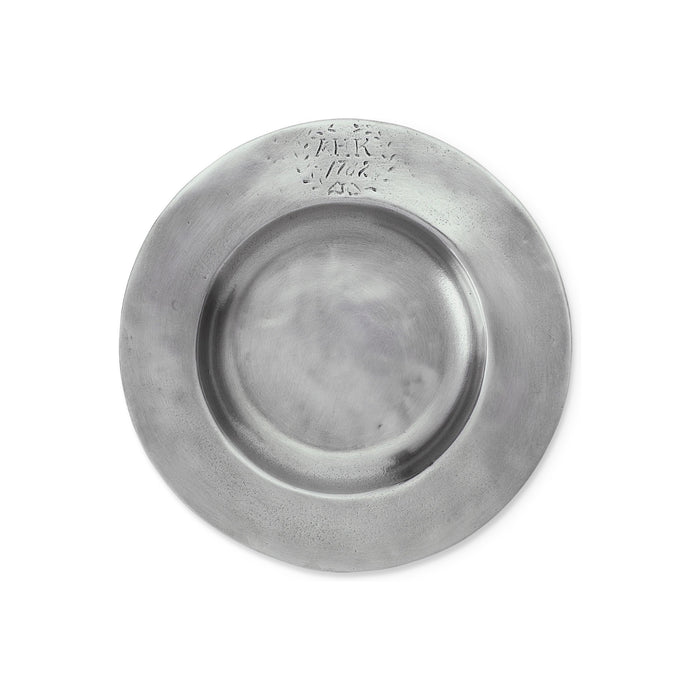 A bottle of red wine with a decorative label stands upright on the MATCH ANTIQUE PEWTER BOTTLE COASTER by MATCH against a plain white background.