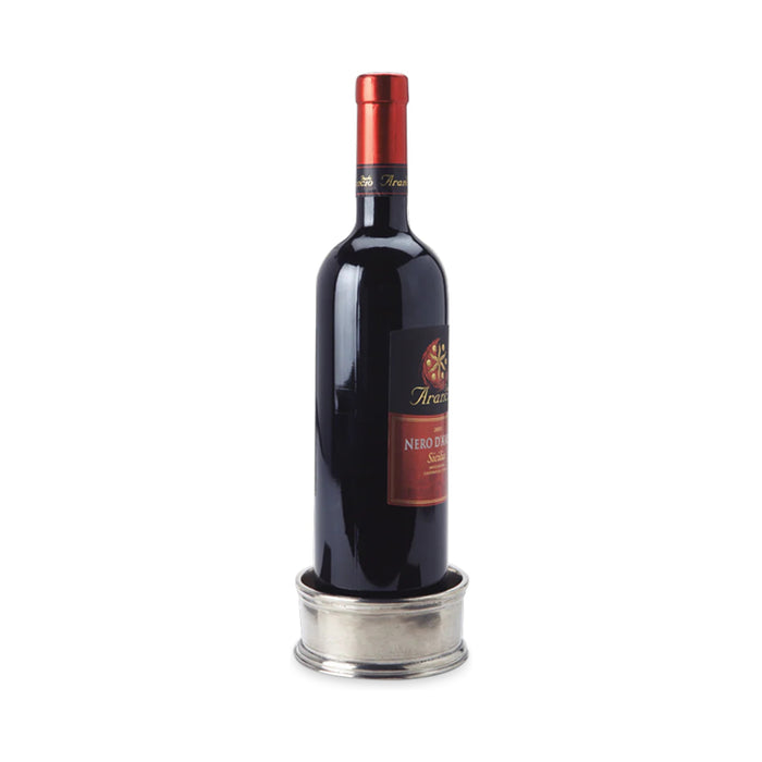 The MATCH Pewter Bottle Coaster with Wood Insert by MATCH features a smooth, round pewter design with subtle engraved lines and a wood insert, crafted from food-safe materials and shown against a white background.