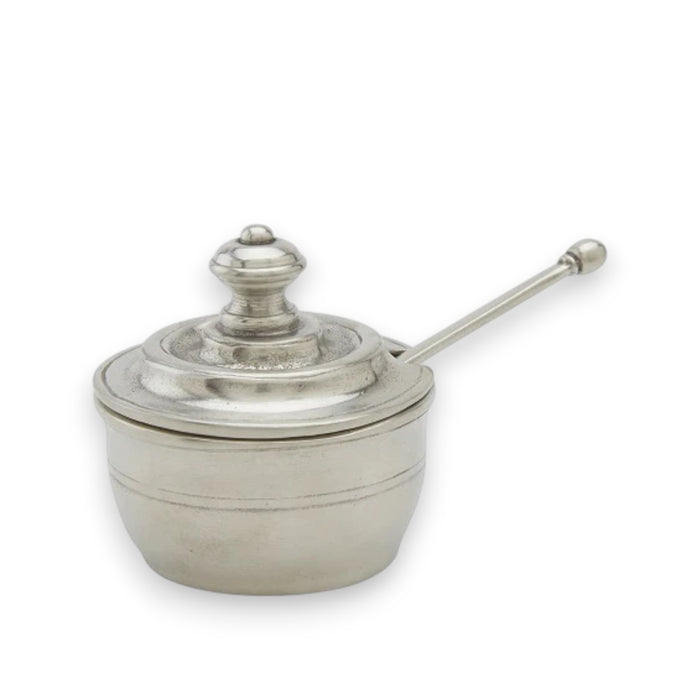 The MATCH Piccolo Salt Cellar with Spoon by MATCH is a small, antique-style pewter pot with a rounded lid, decorative knob, and long handle—perfect as a unique salt cellar. Shown against a plain white background.