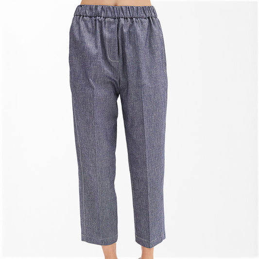 A person wears MEIMEIJ - DENIM COTTON PULL ON PANT: blue, straight-leg, cropped trousers with an elastic waist, subtle textured pattern, and relaxed fit. Made by MEIMEIJ from cotton. Photographed against a white background.
