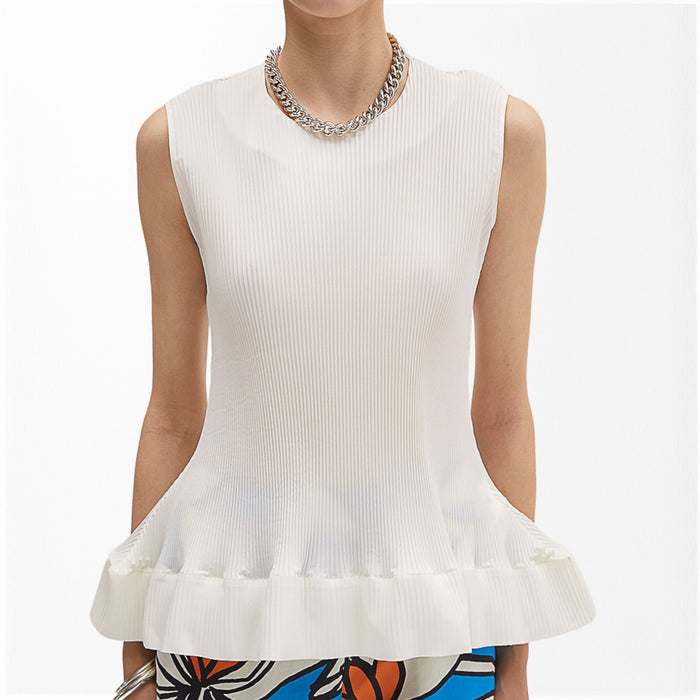 A person wears the MEIMEIJ - PLEATED SLEEVELESS TOP by MEIMEIJ with a silver chain necklace and a vibrant floral skirt, set against a plain white background—a chic choice to pair with summer trousers for effortless style.