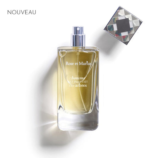 A light blue rectangular box labeled "ROSE ET MARIUS - THE MAN WHO PLANTED TREES EAU DE PARFUM 100ML" features geometric black, white, and gray patterns and hints at a woody fragrance. "Eau de Parfum" and "100 ml" appear at the bottom.